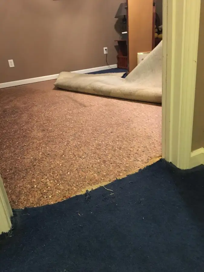 Carpet pad removal revealing water damage during Drying & Dehumidification in Luling