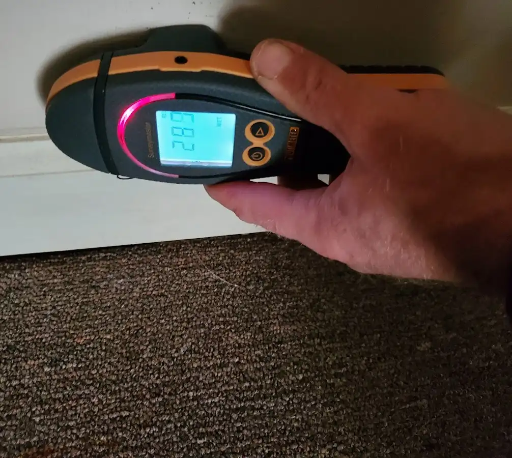 Moisture detection at baseboard during Storm Damage Restoration in Luling